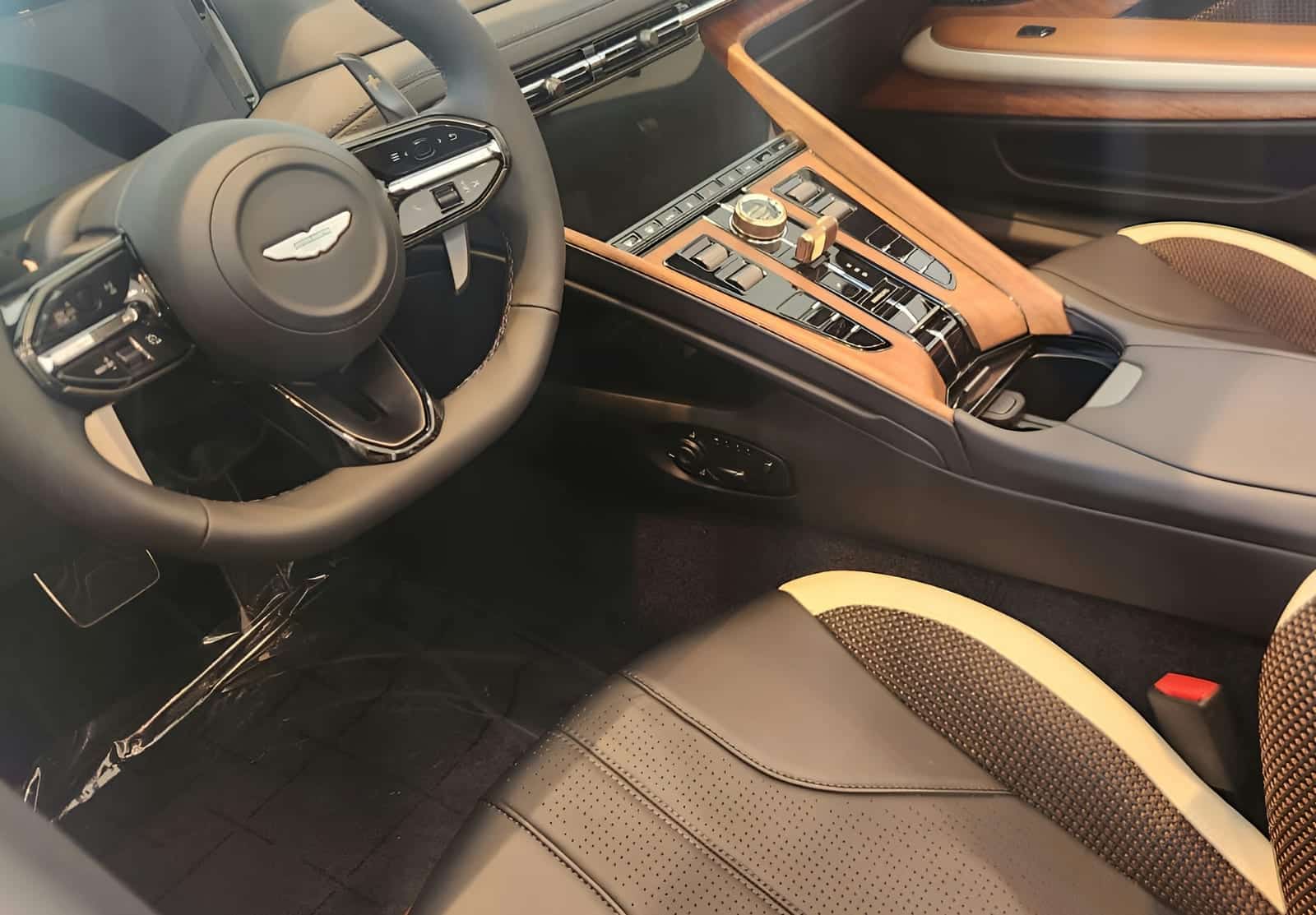 An open-pore walnut console swept clean above two-tone leather.