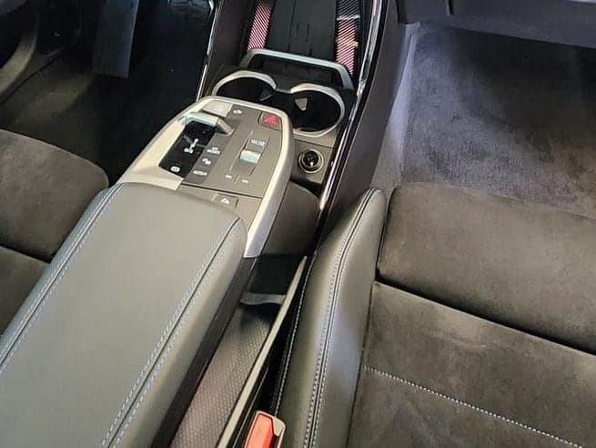 A dark console and soft-textile seats, detailed in private.
