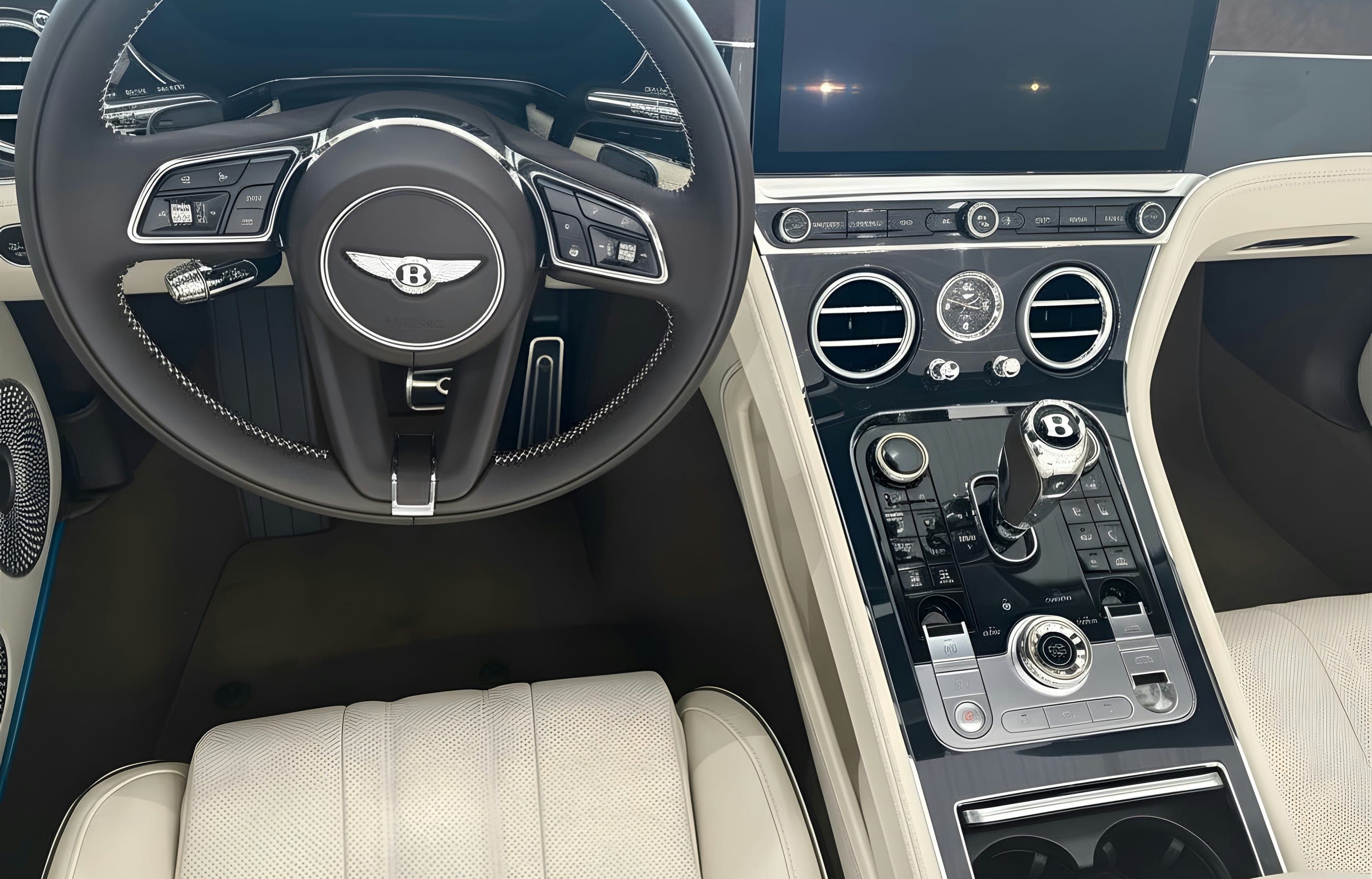 A finished cream-leather cabin detailed front to back — wheel, console, and seats