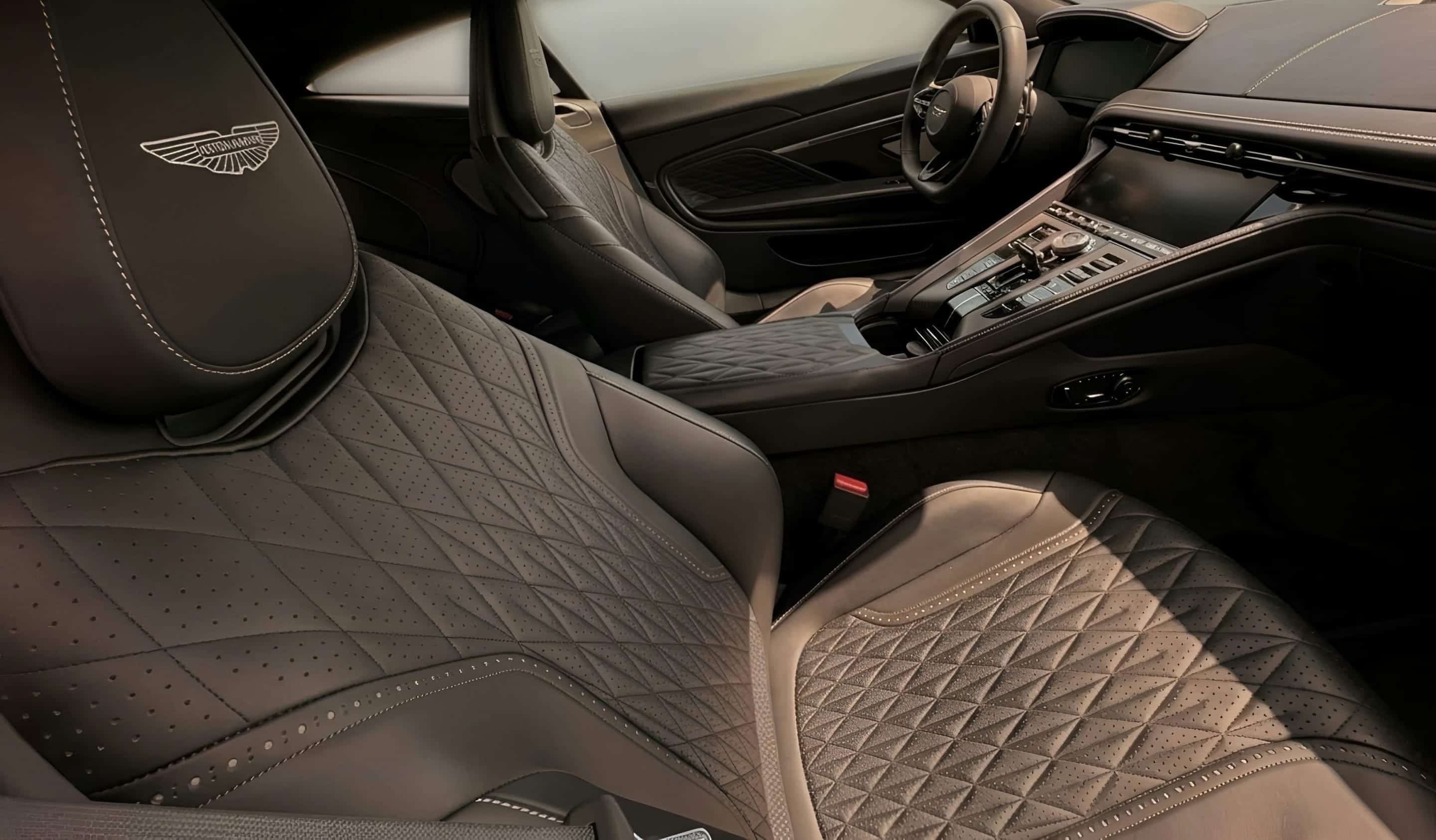 A finished quilted-leather cabin at handover, low light across the stitching.