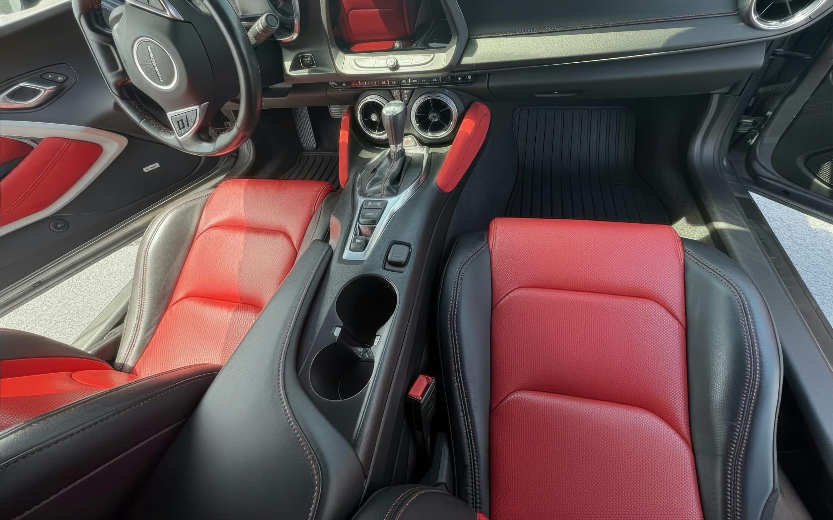 Restored red and black sport interior: bolstered seats, console, and wheel